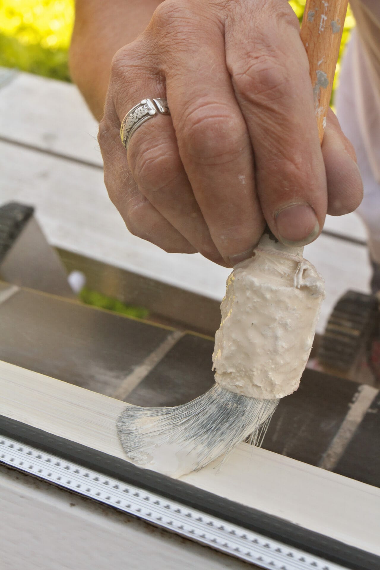 About Us: Painting A Piece Of Wood With Brush.