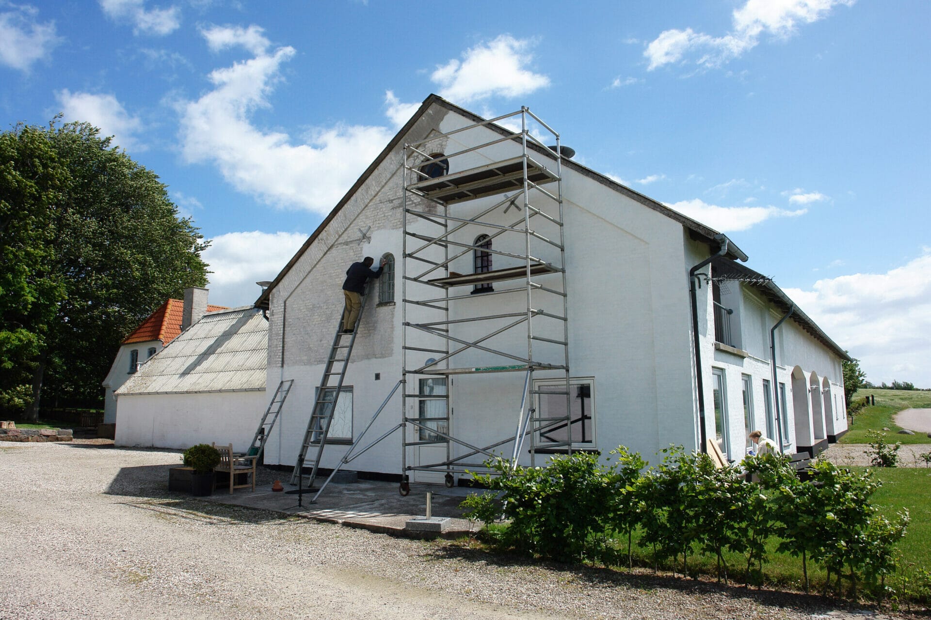 A white home with scaffolding.