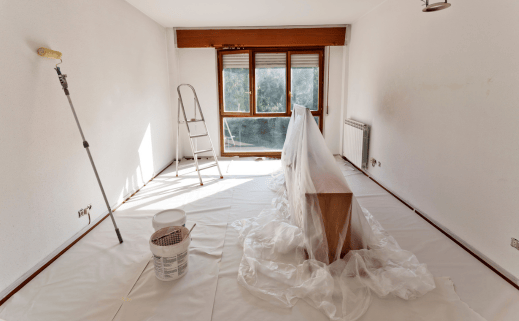 Services: A Room Is Being Painted With Professional Assistance Using White Sheets And A Paint Brush.